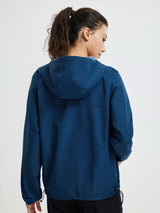 Woman's navy blue packable windbreaker jacket, back view, hood, reflective dots. #color_Navy Blue