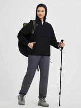 Women's black packable 1/4 zip windbreaker jacket with hood, ready for outdoor adventure.