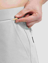 Baleaf 30'' UPF 50+ golf pants: hand tucking golf tee into pocket. #color_Light Gray