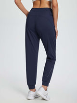 Navy women's drawstring fleece jogger pants with reflective ankle dots. #color_Navy Blue