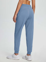 Women's blue drawstring fleece jogger pants with reflective details