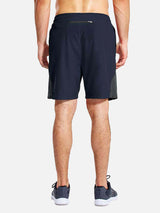 Men's 7" navy running shorts with liner, back zip pocket, and mesh side panels #color_Navy Blue