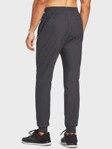 Men's lightweight running jogger pants in dark grey, showing tapered cuffs and zip pocket.