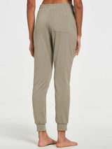 Women's tapered sweatpants in a soft khaki cotton blend, showing back pocket and cuffed hem. #color_Khaki