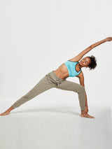 Women's olive green tapered cotton sweatpants in a comfortable yoga pose. #color_Khaki