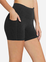 Women's 5" high-waisted compression biker shorts in charcoal heather with tummy control and side pockets. #color_Dark Gray