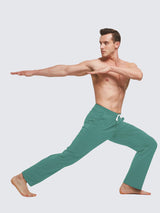 Man in teal straight-leg lounge pants performing a yoga pose, showcasing comfortable and flexible athletic wear. #color_Green