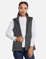 Woman wearing a grey windproof softshell vest over a white long-sleeved shirt and blue jeans. #color_Gray