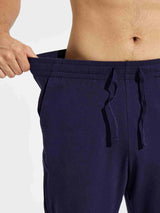 Men's navy blue cotton yoga cargo pants with adjustable drawstring and deep pockets. #color_Navy Blue