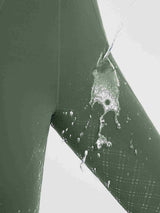 Water beading on green women's full-seat silicone breeches, showing water-repellent fabric. #color_Army Green