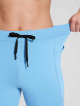 Men's light blue fleece-lined cycling tights detail showing drawstring waist and pocket. #color_Blue