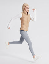 Woman running in grey fleece-lined multi-pocket hiking leggings and beige hooded vest. #color_Gray
