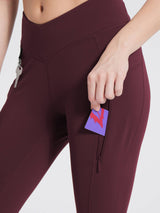 Maroon multi-pocket hiking leggings featuring V-waistband, zippered pocket with card, and key. #color_Wine Red