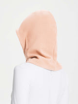 Unisex adjustable fleece ski hat in soft peach color, designed for warmth and outdoor use.