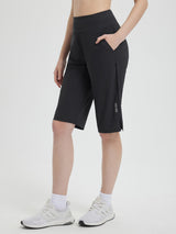 Women's black 14-inch casual cycling capris with elastic waistband, deep side pockets and subtle leg logo. #color_Black