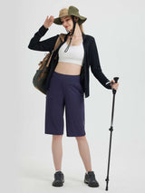 Casual 14 inch navy blue cycling capris on model with outdoor gear.