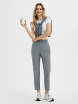 Women's 27" grey golf pants with white tee and sweater. #color_Dark Gray