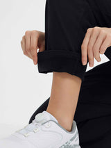 Black fleece-lined slim-fit golf pants with cuff adjustment detail. #color_Black