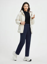 Woman in navy blue pleated fleece slim-fit golf pants and cream jacket #color_Navy Blue