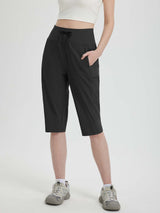 Women's black 15-inch hiking shorts with drawstring waist and cargo pockets for outdoor activities. #color_Black