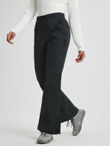 Black women's outdoor softshell straight-leg pants with zipper pockets and snap closures. #color_Black