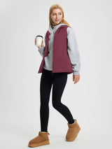 Maroon quilted Dupont insulated vest worn by woman with grey hoodie, black leggings, boots. #color_Wine Red