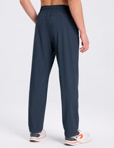 Men's dark blue stretch waist tapered joggers, back view. Features elastic waistband and athletic fit. #color_Navy Blue