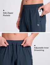 Men's dark navy tapered joggers showcasing secure side zipper pockets and adjustable drawstring waist. #color_Navy Blue