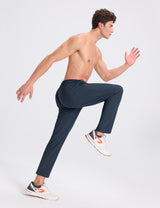 Men's dark navy stretch tapered joggers, elastic waist, modeled running for athletic comfort. #color_Navy Blue