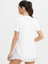 White All-Day Active Set: back view of model in UPF 50+ short sleeve tee and pleated skort. #color_White