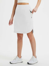 Women's white quick-dry running skort shown with phone in zippered pocket. #color_White