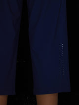Women's navy athletic capris with reflective dots on the side for visibility. #color_Navy Blue