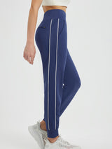 Flat waist fleece-lined navy running joggers with white side stripes and zip pockets. #color_Blue/White