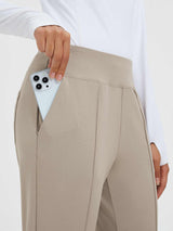 Tan high-waist pants with deep pouch pocket holding smartphone. Stretch fabric. #color_Teak Brown