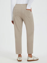 Beige tapered running pants with two back pockets, slim fit, stretch fabric.