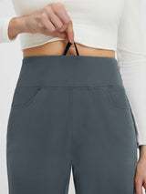 Grey fleece tapered running pants with flat-waist drawstring detail.