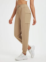 Women's tan fleece cuffed running pants with patchwork pockets and drawstring waist. #color_Tea Brown