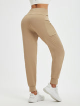 Women's tan fleece running pants with patchwork pockets and cuffed ankles. #color_Tea Brown