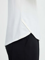 Run-Ready Comfort Set: white long-sleeve running top with cross hem and black high-rise shorts. #color_White