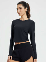Black women's crew-neck long-sleeve running t-shirt with side ruching. #Color_Black