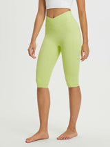 Women's 14" high-waisted crossover capris in light green with two side pockets and a V-shaped waistband. #color_Light Green