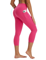 Women's bright pink high-waisted capris with phone pocket, zipper, and butt-lifting design. #color_Rose Red