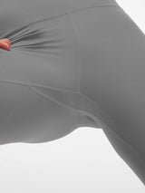 Close-up of grey women's high-waisted capris showing fabric stretch and seam detail. #color_Dark Gray