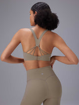 Taupe yoga set: strappy back sports bra and high-rise shorts for comfortable movement. #color_Brown