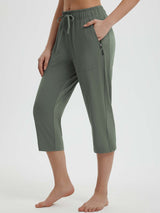 Green women's 19-inch quick-dry yoga capri pants with drawstring and zip pockets. #color_Army Green