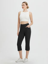 Woman wearing black Baleaf high-waisted capris with side pockets and white sneakers. #color_Black