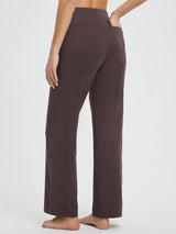 Yoga Commuter high-waisted wide-leg pants in brown, back view with hand in pocket. #Color_Dark Brown