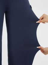 Stretch fabric detail on navy blue Yoga Commuter high-waisted wide-leg pants. #Color_Navy Blue