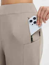 High waisted yoga tapered pants in tan with a secure zippered pocket for phone storage. Stretchy fabric. #color_Teak Brown