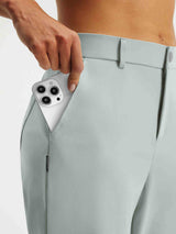 Baleaf Stretchy Golf Pant: Hand inserts smartphone into deep side pocket, light blue. #color_Light Gray